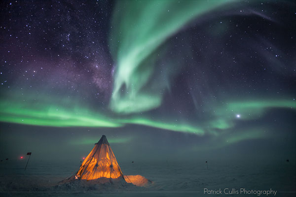 A Scott Tent set up at the South Pole in Antarctica.&nbsp; Aurora and the Milky Way in the sky above.
